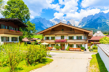 Fototapeta na wymiar Traditional alpine houses in village of Going am Wilden Kaiser on beautiful sunny summer day, Tirol, Austria