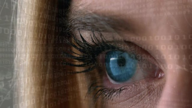 Digital composite of a woman eye looking at the coding system