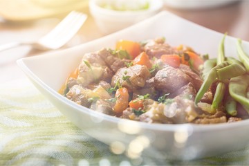 Tasty meat in white plate on light background
