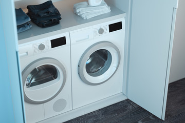 Washing and dryer machines with detergent and clothes above. 3d rendering.
