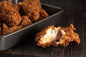 Batch of Crispy Homemade Fried Chicken on a Rustic Wooden Table