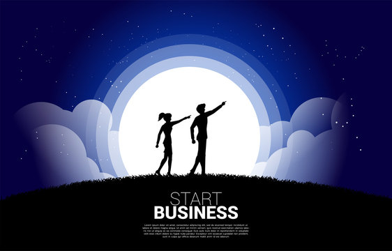 Silhouette Of Businesswoman And Business Man Point Forward Ahead At Night. Concept Of Vision Mission And Entrepreneur