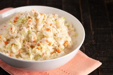 Bowl of Coleslaw on a Distressed Wooden Table