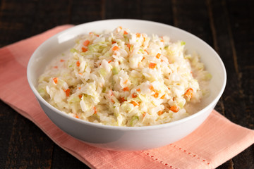 Bowl of Coleslaw on a Distressed Wooden Table