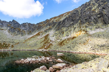 Hiking in High Tatras Mountains (Vysoke Tatry), Slovakia. On the way to Furkotsky Stit mount (2403m). Capie Pleso lake (2075m). Largest lake in the Mlynicka Valley in Tatras