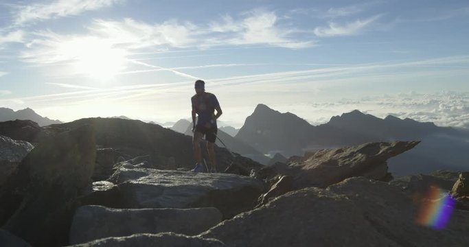 Man climbing run on mountain rise.Trail runner running to top peak training on rocky climb.Wild green nature outdoors at sunrise or sunset. Activity,sport,effort,challenge,willpower concepts