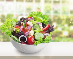 Close-up photo of fresh salad with vegetables in white plate