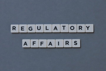 ' Regulatory Affairs ' word made of square letter word on grey background.