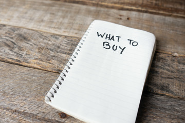 What to buy words written with black marker on  notebook