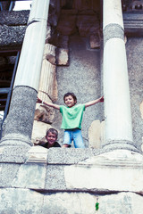 Fototapeta premium little boy exploring ancient architecture, lifestyle people on summer vacation close up