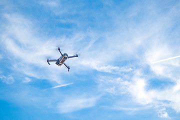 Fototapeta na wymiar drone hovering in blue sky