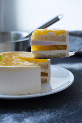 Mango fruit Mousse Cake, decorated with fresh fruits in jelly. Whipped cheese with biscuits