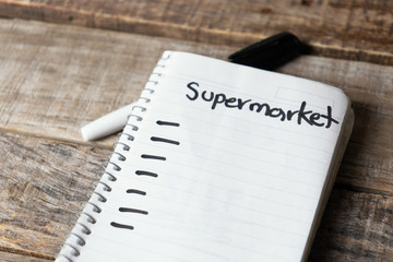 Supermakert list blank written with black marker on  notebook