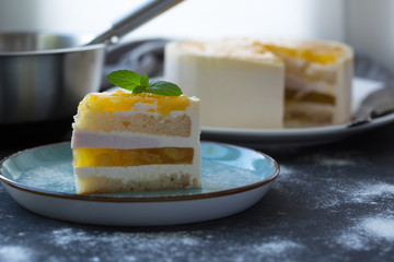 Mango fruit Mousse Cake, decorated with fresh fruits in jelly. Whipped cheese with biscuits