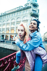 Two teenage girls infront of university building smiling, having fun, lifestyle real people concept close up