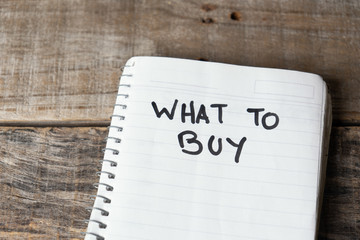 What to buy words written with black marker on  notebook