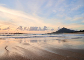 Beach of moledo at the end of the day, with a view to trega mountain on spanish side of the border. Low tide displaying the sandy beach on a cloudy day.