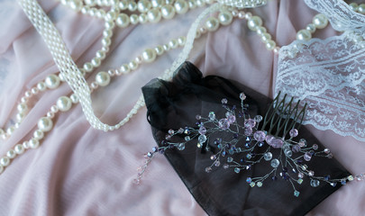 Wedding background with pearls and hair accessories on pink background