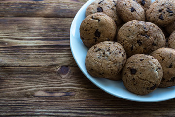 Pile of Delicious Chocolate Chip Cookies on a plate on wooden table