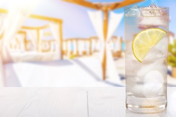 Glass of cocktail with ice and lemon isolated on white background