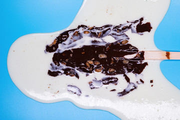 chocolate outer popsicle with beans melted on blue background