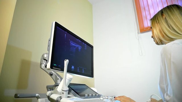 Doctor Taking A Sonogram on ultrasound machine