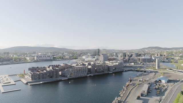 4K aerial with forward motion of the Oslo fjord, downtown Oslo and Bjoervika district, with the new Edvard Munch museum Lambda, Barcode quarter, Soerenga pier and Oslo Opera House.