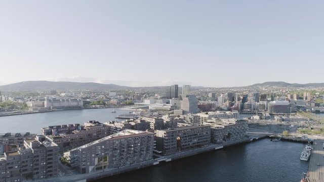 4K aerial with forward motion of the Oslo fjord, downtown Oslo and Bjoervika district, with the new Edvard Munch museum Lambda, Barcode quarter, Soerenga pier and Oslo Opera House.