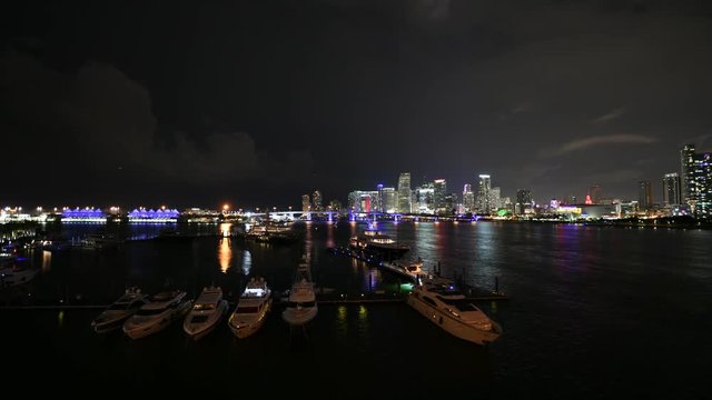 Night time lapse of Miami city viewed across Biscayne bay in Florida, USA