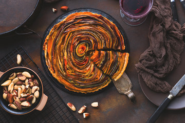 Spiral Gemüse Tarte auf bunt dekoriertem tisch.