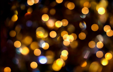 Fototapeta premium Blurred bokeh background, light effect, glitter, flaming lights, holiday, yellow circles on black, Christmas, fun