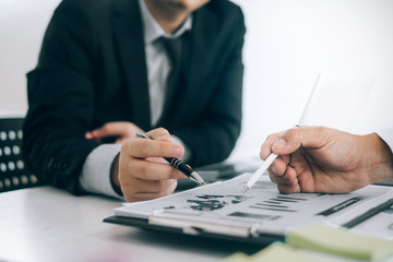 Business people analyzing investment graph meeting brainstorming and discussing plan in meeting room, investment concept