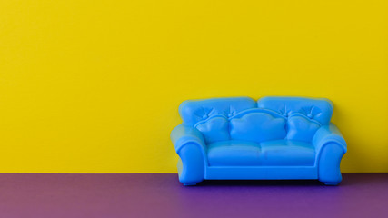 Beautiful blue sofa on the purple floor at the yellow wall. A sample of beautiful furniture for the house.