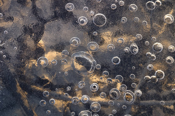 Texture abstract closeup background ice with grooves, furrows, and bubbles of air cought by frost...