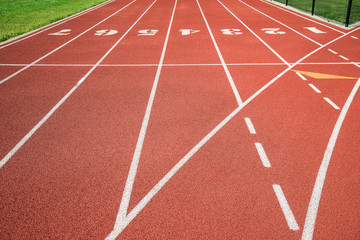 Red running track, track and field or athletics track start line with lane numbers