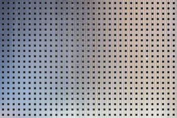 perforated metal seamless texture. sheet of metal covered with square holes. industrial background