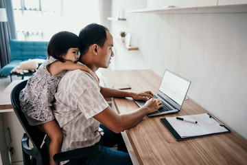 young business man parent interrupts by her daughter while working in the office