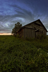 Round Clouds Over An Old Barn House