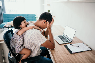 portrait of father feels stressed when his daughter interrupts work