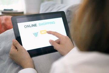 Women hand into online shopping websites on smartphones such as tablet.