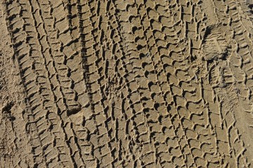 Four wheel drive vertical tyre marks in sand background