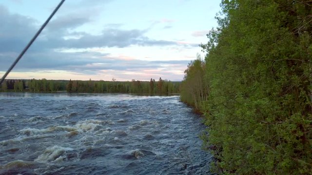 Suspension bridge on Glomma River in the forest in Hedmark county in Norway