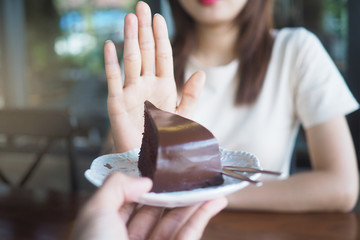 One of the health-care girls used a hand to push a plate of chocolate cake. Refuse to eat foods...