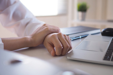 Fototapeta premium Businesswoman has a pain in her wrist from using the computer for a long time. Office syndrome