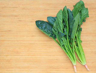 Fresh spinach on wooden board.
