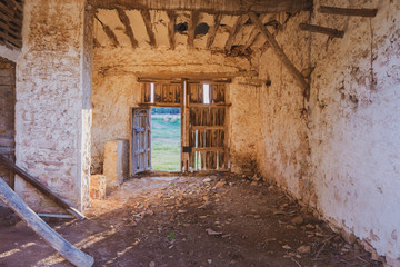 Fototapeta na wymiar interior of abandoned and dilapidated house with broken wooden door.