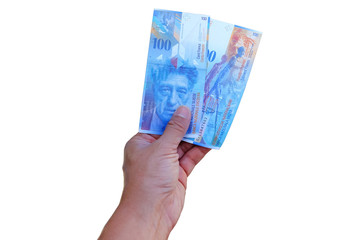  Swiss francs banknotes hold in male hand withe isolated on white background