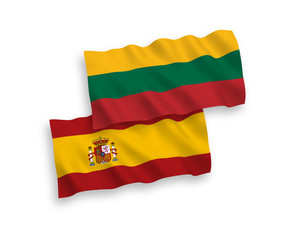 National vector fabric wave flags of Lithuania and Spain isolated on white background. 1 to 2 proportion.