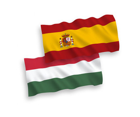 National vector fabric wave flags of Spain and Hungary isolated on white background. 1 to 2 proportion.