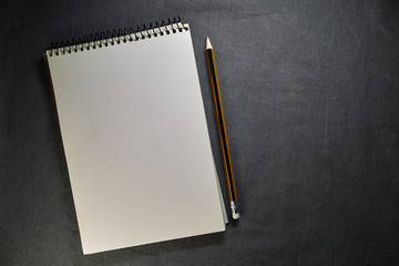 school notebook on a gray background, spiral notepad on a table